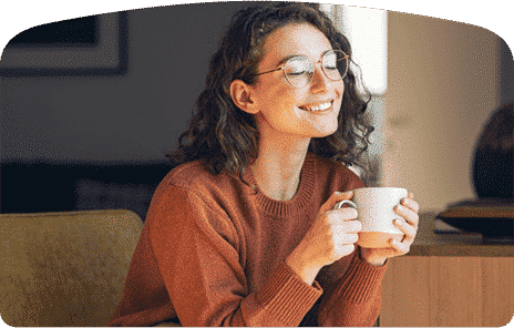 woman holding a cup while smiling