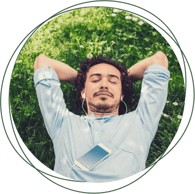 man lying down with his hands on the back of his head with a headset